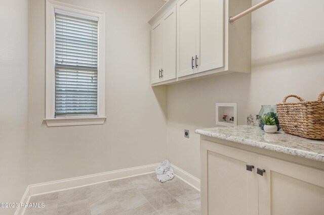 laundry room with hookup for a washing machine, cabinets, and hookup for an electric dryer