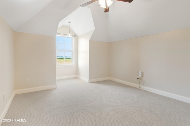 bonus room with ceiling fan, light colored carpet, and vaulted ceiling