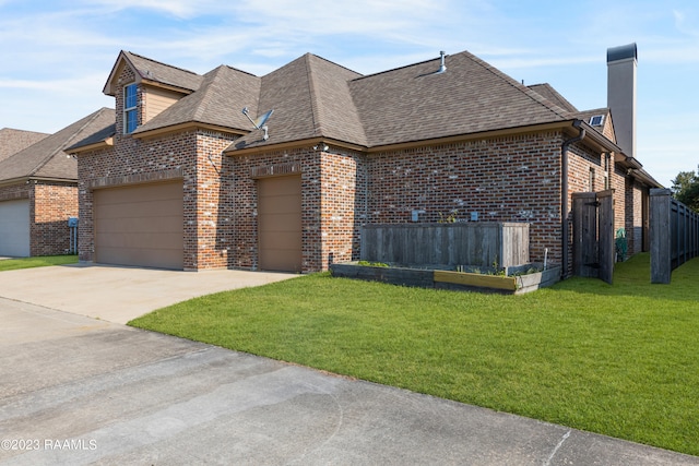 view of front of home with a front yard and a garage