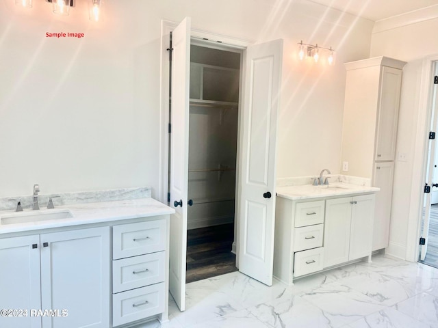 bathroom featuring vanity and ornamental molding