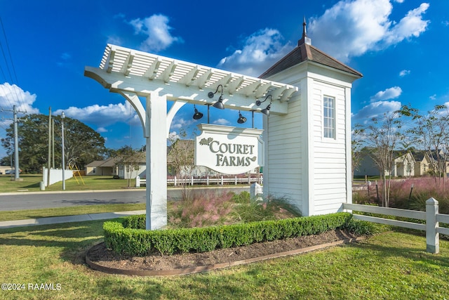 community / neighborhood sign featuring a lawn