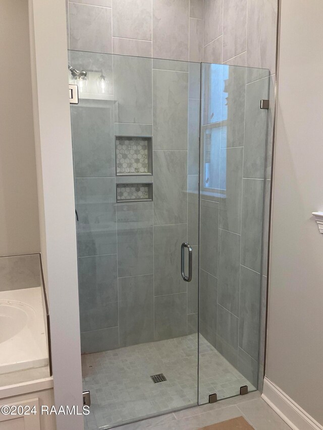 bathroom featuring tile patterned floors and an enclosed shower