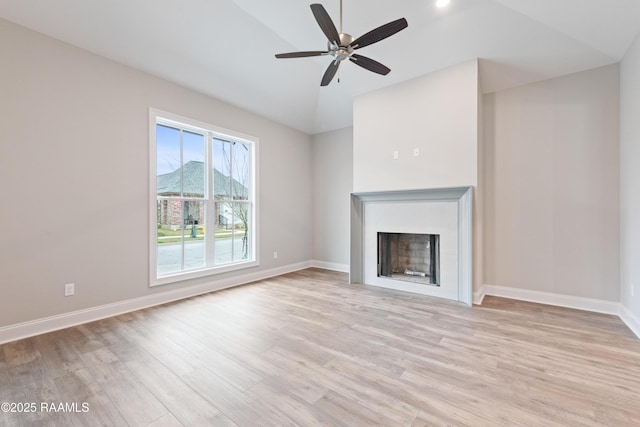 unfurnished living room featuring a fireplace, light wood-style flooring, and baseboards