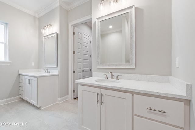 full bathroom with baseboards, ornamental molding, two vanities, and a sink