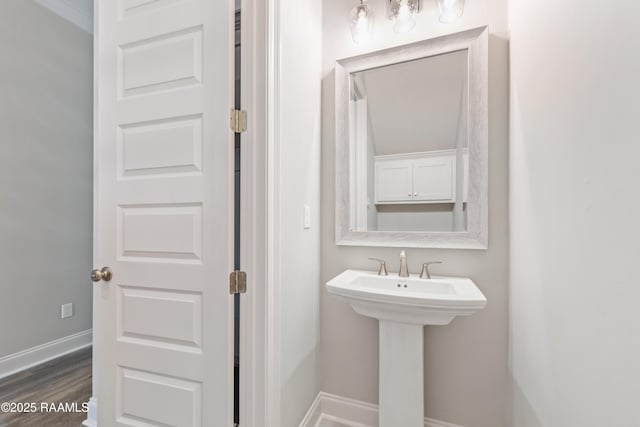 bathroom with wood finished floors and baseboards