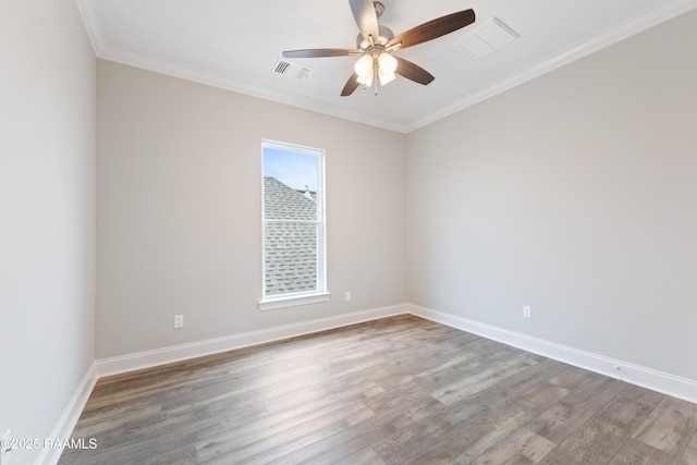 empty room with visible vents, baseboards, and wood finished floors