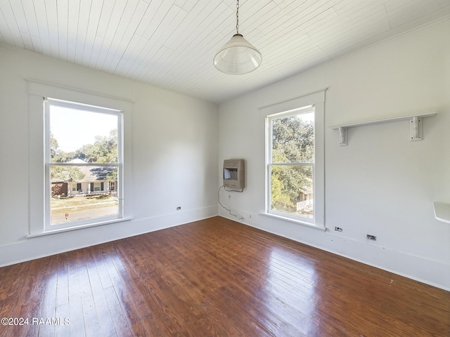 spare room with hardwood / wood-style flooring, heating unit, and wooden ceiling