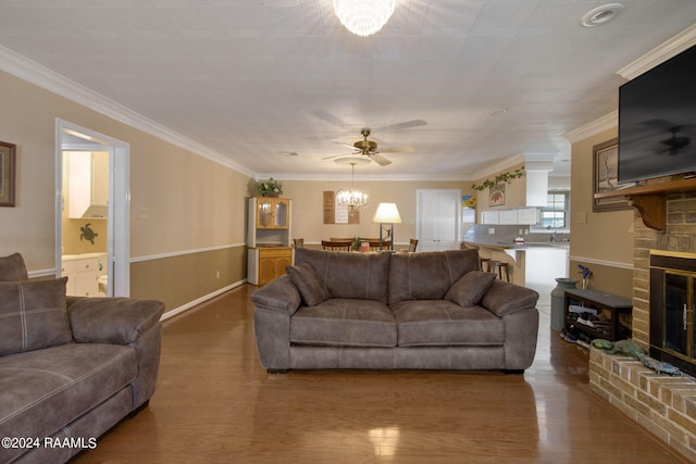 living room with hardwood / wood-style floors, a fireplace, and ornamental molding