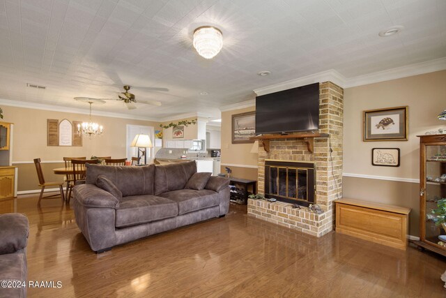 living room featuring hardwood / wood-style flooring, a fireplace, and ornamental molding