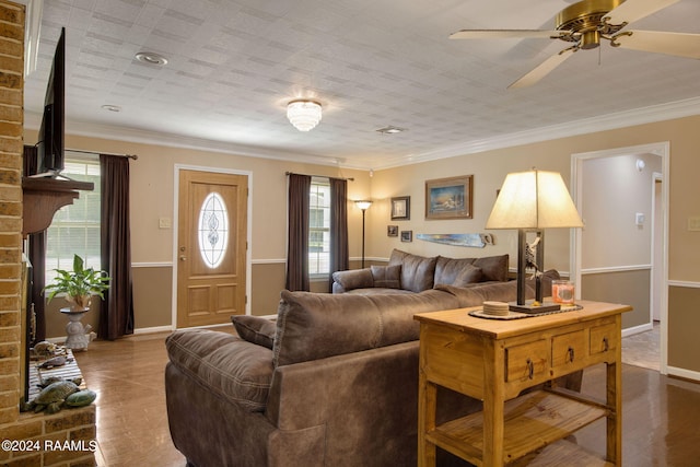 living room with hardwood / wood-style floors, ceiling fan, a fireplace, and ornamental molding