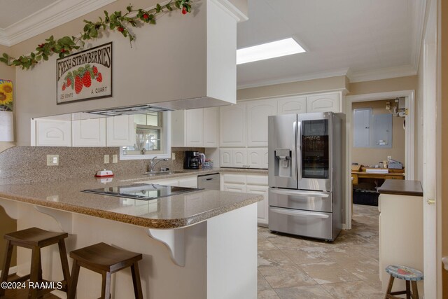 kitchen with white cabinets, kitchen peninsula, a breakfast bar area, stainless steel fridge with ice dispenser, and ornamental molding