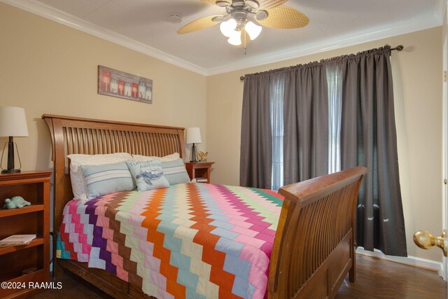 bedroom with dark wood-type flooring, ceiling fan, and crown molding