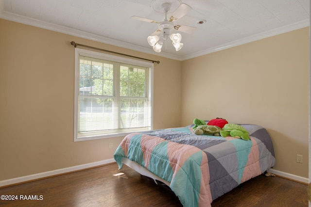 bedroom featuring dark wood-type flooring, ceiling fan, and ornamental molding