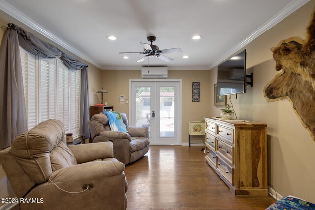 living room with dark wood-type flooring, ceiling fan, ornamental molding, and a wall unit AC