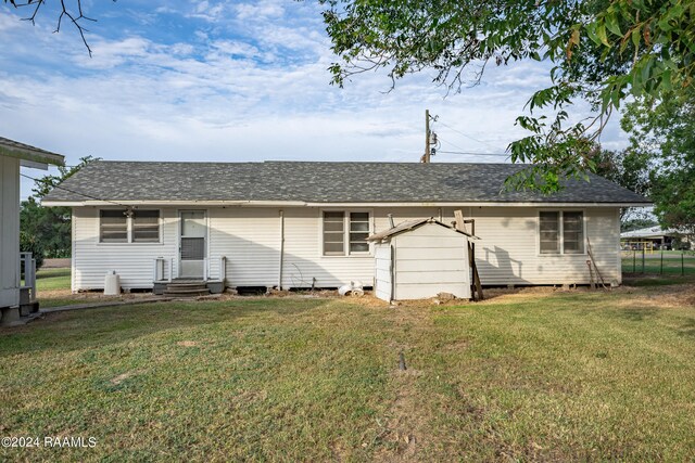 back of house with a lawn