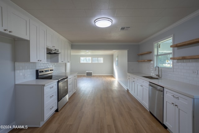 kitchen with white cabinets, appliances with stainless steel finishes, plenty of natural light, and sink