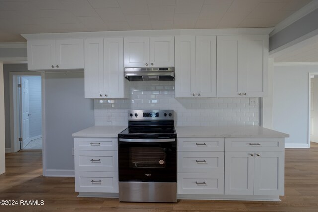 kitchen with electric range, tasteful backsplash, white cabinets, light hardwood / wood-style flooring, and ornamental molding