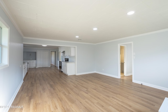 unfurnished living room featuring ornamental molding and light hardwood / wood-style flooring