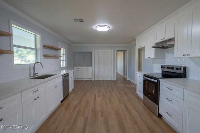 kitchen featuring ornamental molding, sink, light hardwood / wood-style flooring, white cabinetry, and stainless steel appliances