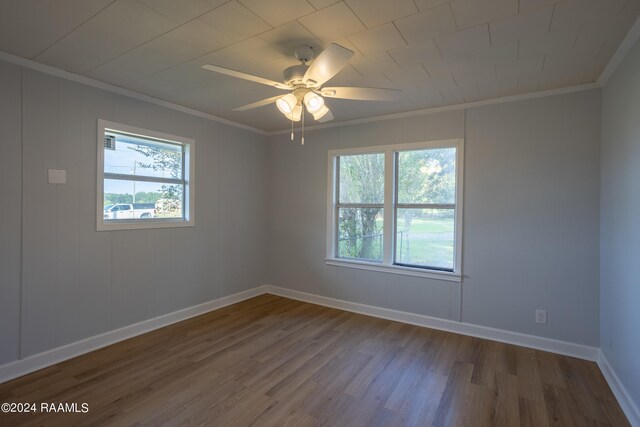 empty room featuring ornamental molding, ceiling fan, plenty of natural light, and hardwood / wood-style floors