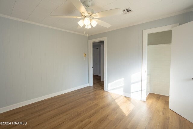 unfurnished bedroom with ceiling fan, light hardwood / wood-style flooring, and crown molding