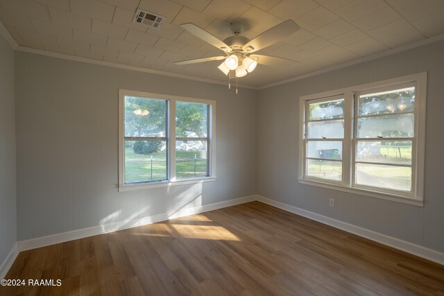 unfurnished room featuring ceiling fan, ornamental molding, and dark hardwood / wood-style flooring