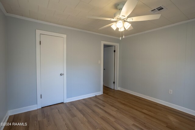 unfurnished bedroom featuring ceiling fan, hardwood / wood-style flooring, and ornamental molding