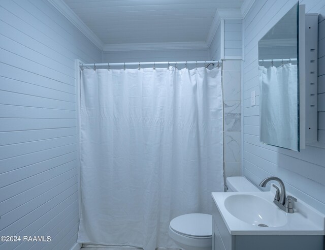 bathroom with vanity, wood walls, walk in shower, crown molding, and toilet