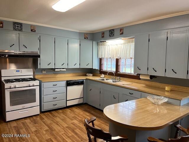 kitchen with wooden counters, light wood-type flooring, white range with gas stovetop, sink, and dishwashing machine