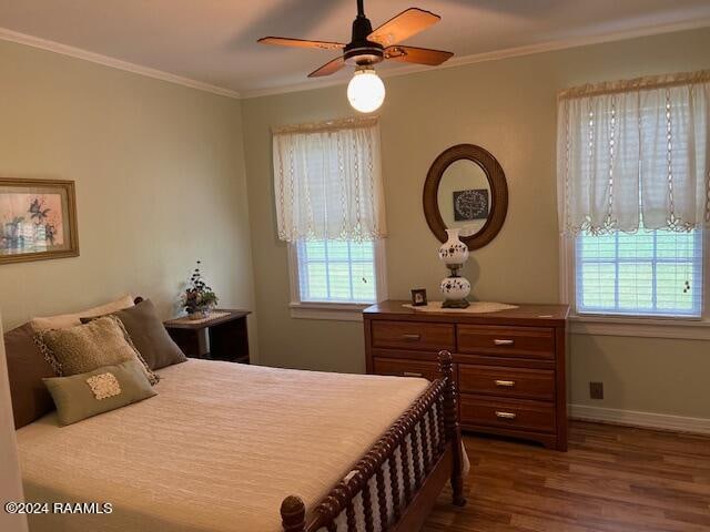 bedroom featuring ornamental molding, hardwood / wood-style flooring, and ceiling fan