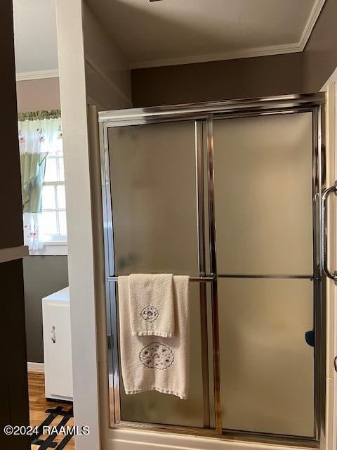 bathroom featuring an enclosed shower and hardwood / wood-style floors