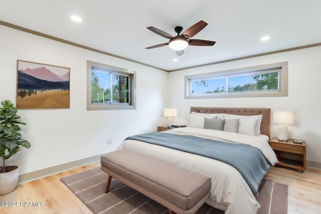 bedroom featuring ceiling fan, light wood-type flooring, and crown molding