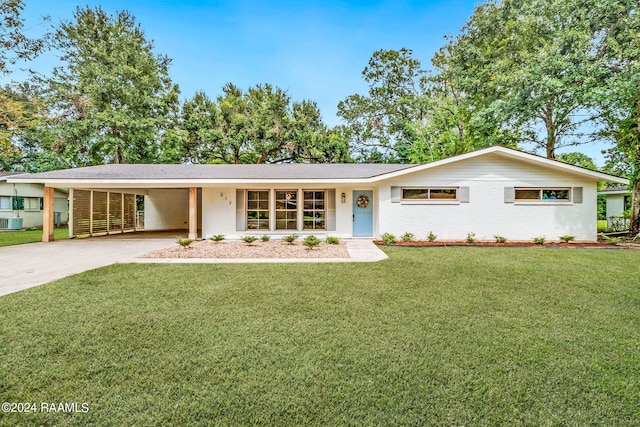 ranch-style house featuring cooling unit, a carport, and a front lawn