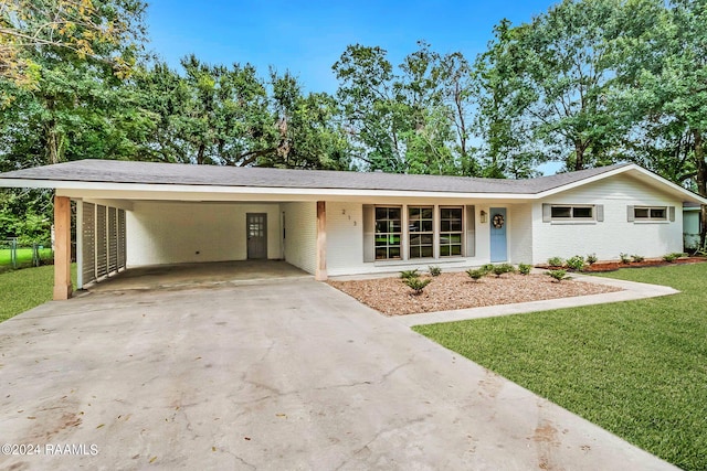 single story home with a front lawn and a carport