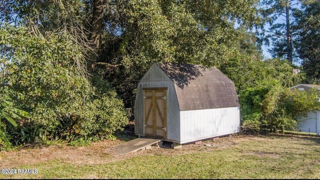 view of outbuilding featuring a yard