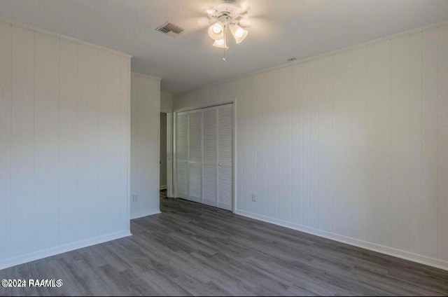 spare room featuring dark wood-type flooring and ceiling fan