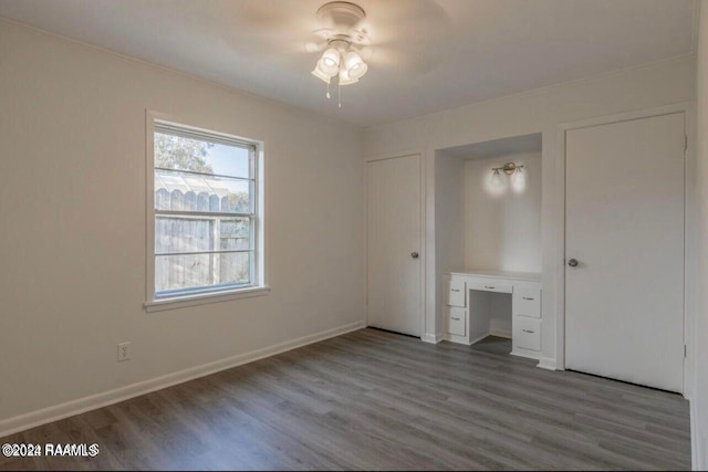 unfurnished bedroom with hardwood / wood-style floors and ceiling fan