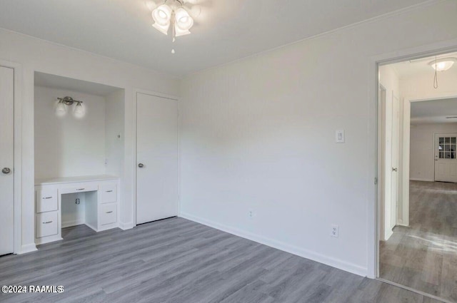 unfurnished bedroom with hardwood / wood-style floors