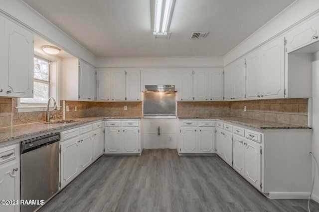 kitchen featuring dishwasher, sink, light wood-type flooring, and white cabinetry