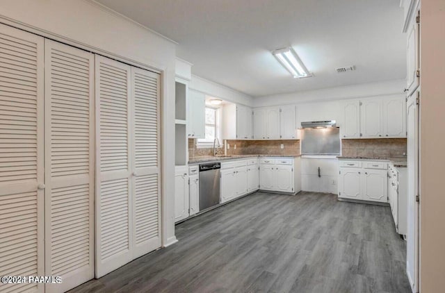 kitchen featuring dishwasher, wood-type flooring, tasteful backsplash, ornamental molding, and white cabinetry