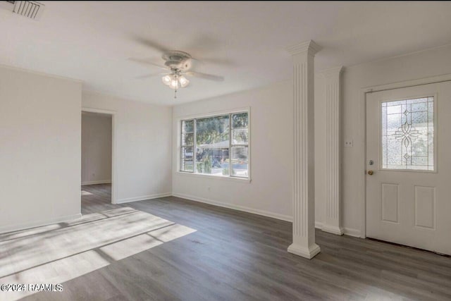 foyer with plenty of natural light, ornate columns, wood-type flooring, and ceiling fan