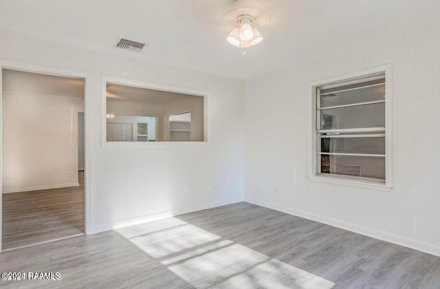 empty room with light hardwood / wood-style flooring