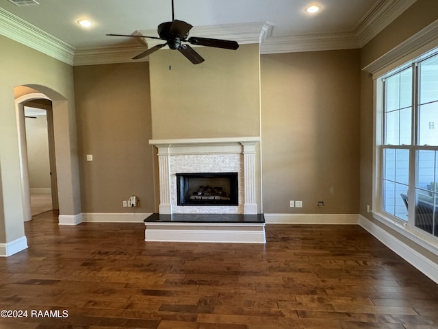 unfurnished living room featuring crown molding, ceiling fan, and dark hardwood / wood-style flooring