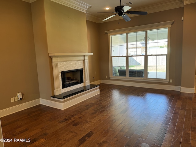 unfurnished living room with ceiling fan, a tile fireplace, dark hardwood / wood-style flooring, and a healthy amount of sunlight