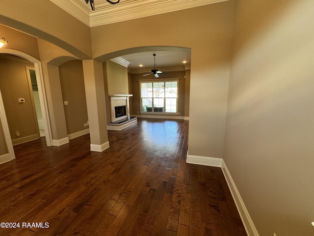 interior space featuring crown molding, dark wood-type flooring, and a high ceiling