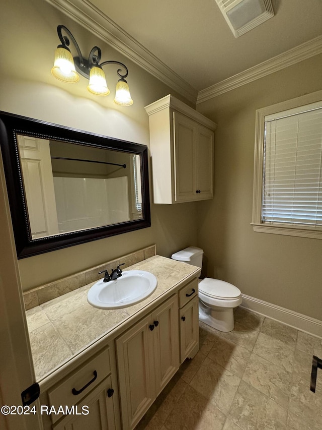 bathroom featuring vanity, toilet, and ornamental molding