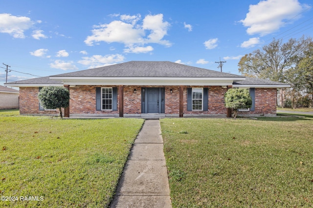 single story home featuring a front yard and covered porch