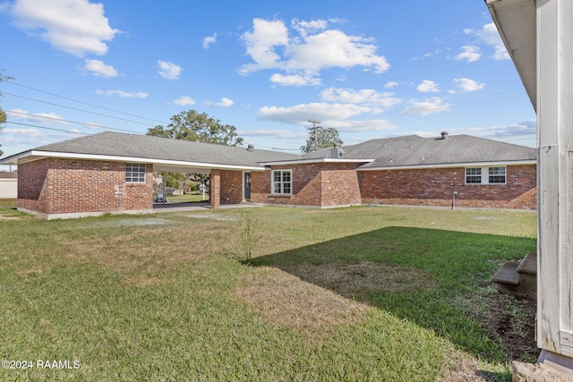 rear view of house with a yard