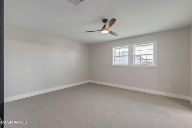 carpeted empty room featuring ceiling fan