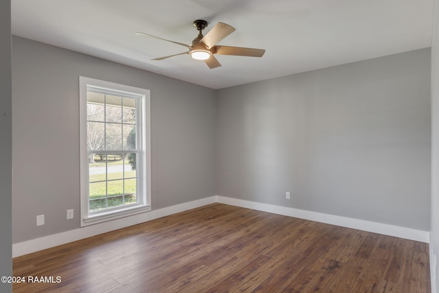 empty room featuring dark hardwood / wood-style floors, a healthy amount of sunlight, and ceiling fan